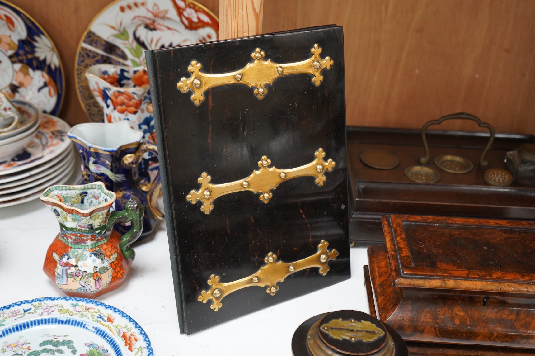 A collection of sundry items to include a Coromandel and brass mounted ink blotter pad, an early 19th century French yew veneered travelling writing box, an early 19th century mahogany desk stand and burr walnut bombé sh